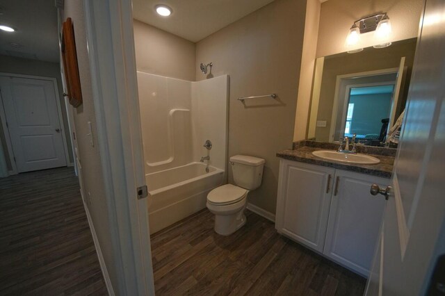 5594 Riviera Dr, Milton, FL 32583 - full bath featuring vanity, toilet, baseboards, wood finished floors, and  shower combination