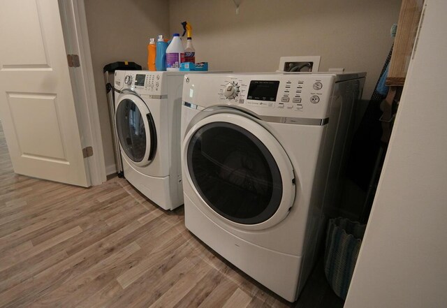 5594 Riviera Dr, Milton, FL 32583 - laundry area featuring separate washer and dryer and light wood finished floors