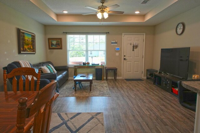 5594 Riviera Dr, Milton, FL 32583 - living room with baseboards, ceiling fan, a tray ceiling, and wood finished floors