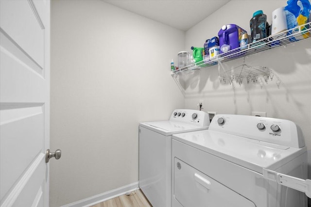 810 Otto Loop, Crestview, FL 32539 - laundry area with baseboards, laundry area, light wood-type flooring, and washer and clothes dryer