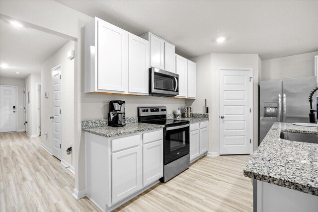 810 Otto Loop, Crestview, FL 32539 - kitchen with baseboards, light wood finished floors, appliances with stainless steel finishes, and a sink