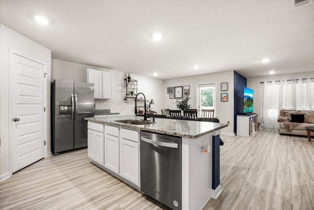 810 Otto Loop, Crestview, FL 32539 - kitchen featuring a kitchen island with sink, light wood-style floors, stainless steel appliances, and a sink