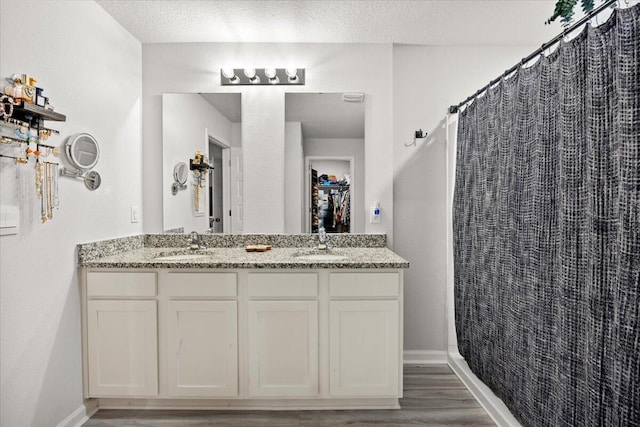 810 Otto Loop, Crestview, FL 32539 - full bath featuring a sink, double vanity, baseboards, and wood finished floors