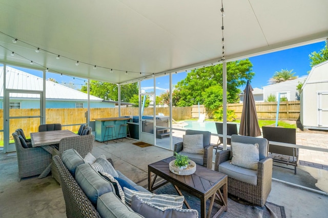 view of patio featuring a fenced backyard, a storage unit, outdoor dining space, and an outdoor living space