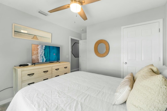 bedroom with visible vents, baseboards, and ceiling fan
