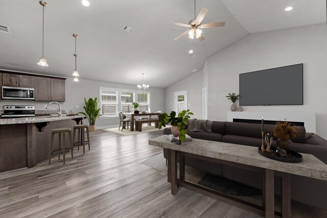 7424 Gordon Evans Rd, Navarre, FL 32566 - living area with lofted ceiling, light wood-style flooring, recessed lighting, a chandelier, and a ceiling fan