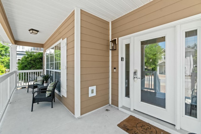 view of exterior entry with a porch