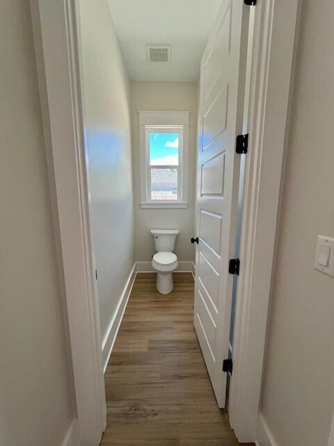 149 Leap Year Ln, Freeport, FL 32439 - bathroom with toilet, baseboards, visible vents, and wood finished floors