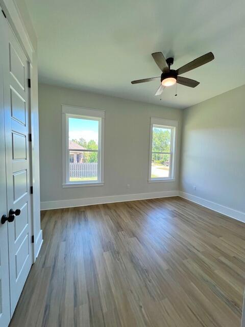 149 Leap Year Ln, Freeport, FL 32439 - spare room featuring wood finished floors, baseboards, and a ceiling fan