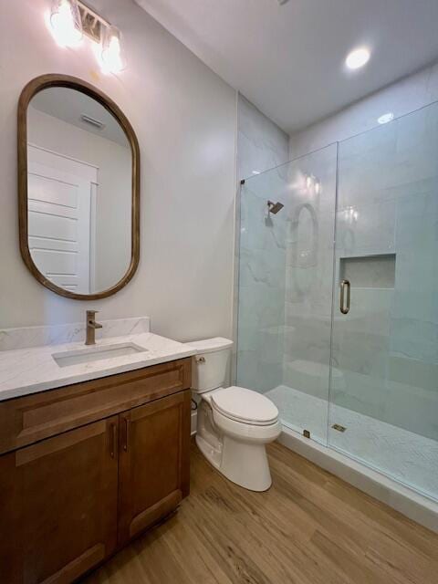 149 Leap Year Ln, Freeport, FL 32439 - bathroom with vanity, toilet, wood finished floors, and a stall shower