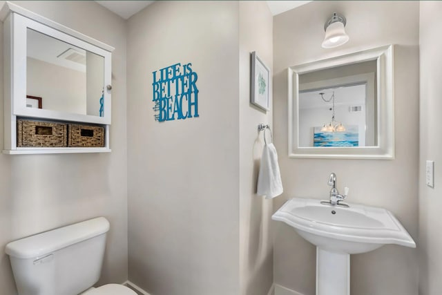 1110 Santa Rosa Blvd Unit A616, Fort Walton Beach, FL 32548 - bathroom with toilet, a sink, visible vents, and baseboards