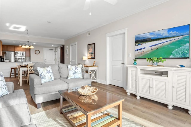 1110 Santa Rosa Blvd Unit A616, Fort Walton Beach, FL 32548 - living area featuring ornamental molding, ceiling fan with notable chandelier, visible vents, and light wood-type flooring
