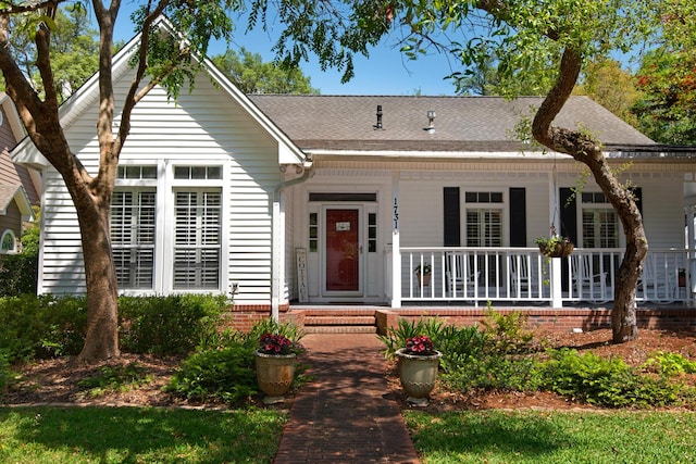 view of front of property with covered porch and a shingled roof