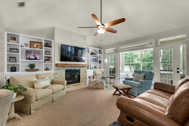 living room with ceiling fan, a fireplace, carpet floors, vaulted ceiling, and visible vents
