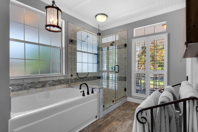 bathroom featuring a shower stall, a garden tub, wood finished floors, and a wealth of natural light