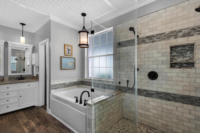 bathroom with a bath, a stall shower, wood finished floors, vanity, and ornamental molding