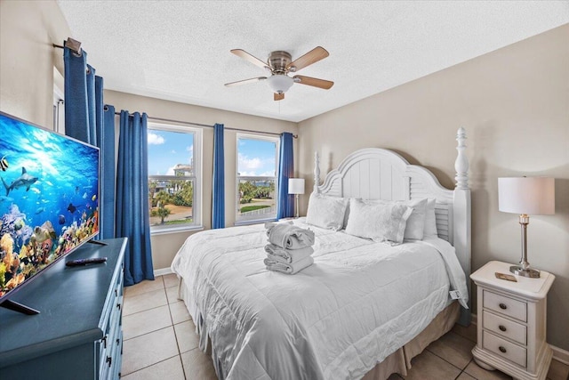 300 Gulf Shore Dr Unit 308, Destin, FL 32541 - bedroom featuring a textured ceiling, a ceiling fan, baseboards, and light tile patterned floors
