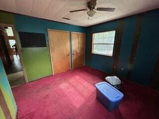 unfurnished bedroom featuring carpet floors and ceiling fan