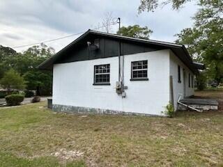 view of side of home with a yard