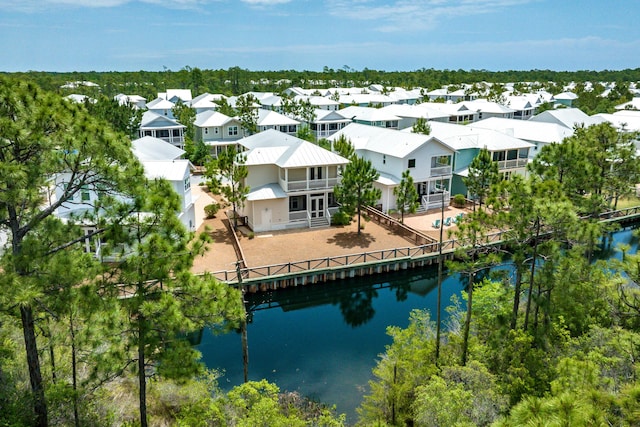 aerial view of residential area featuring a large body of water
