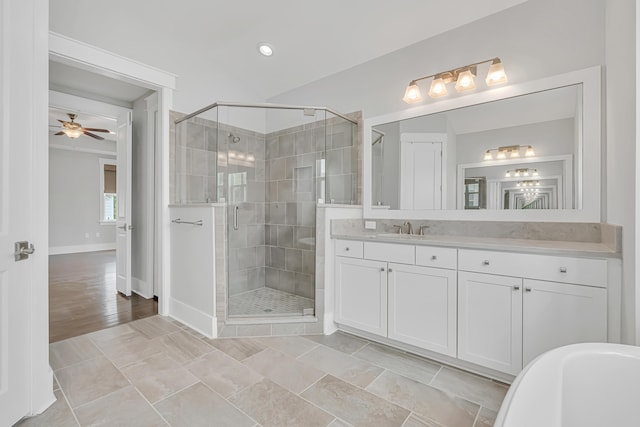 full bath with a shower stall, vanity, baseboards, and ceiling fan