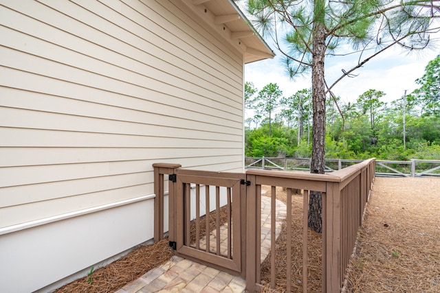 wooden terrace featuring a gate and fence