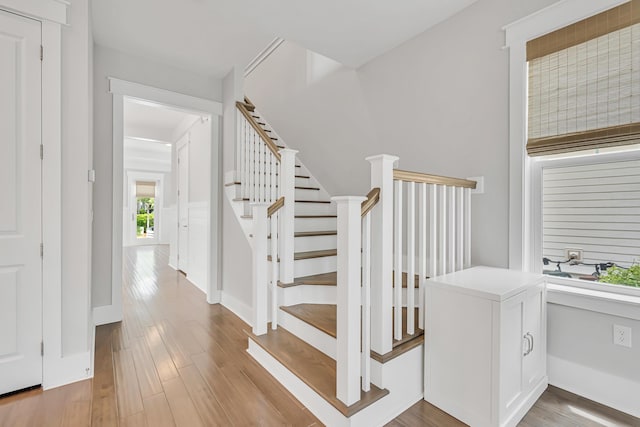 stairway featuring wood finished floors and baseboards