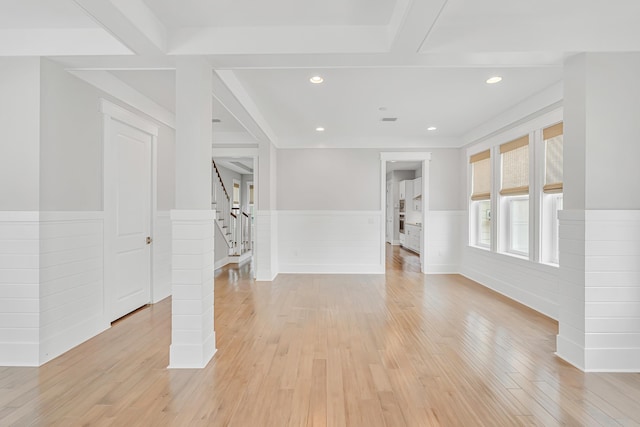 unfurnished living room with a wainscoted wall, stairway, light wood-type flooring, and recessed lighting