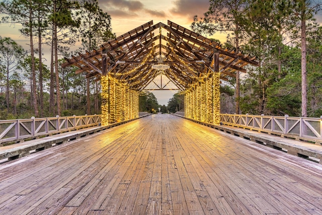 wooden terrace with view of wooded area