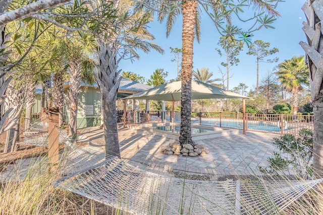 view of patio / terrace with a community pool and fence