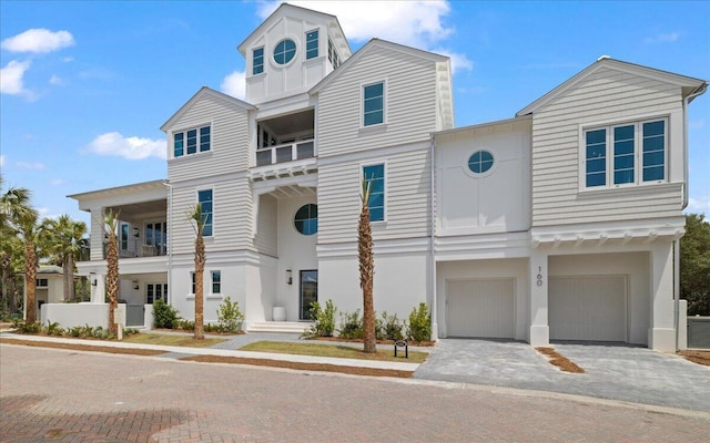 160 Heritage Dunes Ln S, Santa Rosa Beach, FL 32459 - view of front of property with an attached garage, decorative driveway, stucco siding, and a balcony