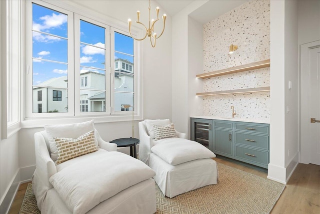 160 Heritage Dunes Ln S, Santa Rosa Beach, FL 32459 - living area with wet bar, baseboards, a notable chandelier, and light wood-style floors