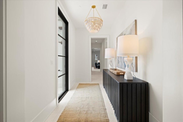 160 Heritage Dunes Ln S, Santa Rosa Beach, FL 32459 - hallway featuring a chandelier, baseboards, and visible vents