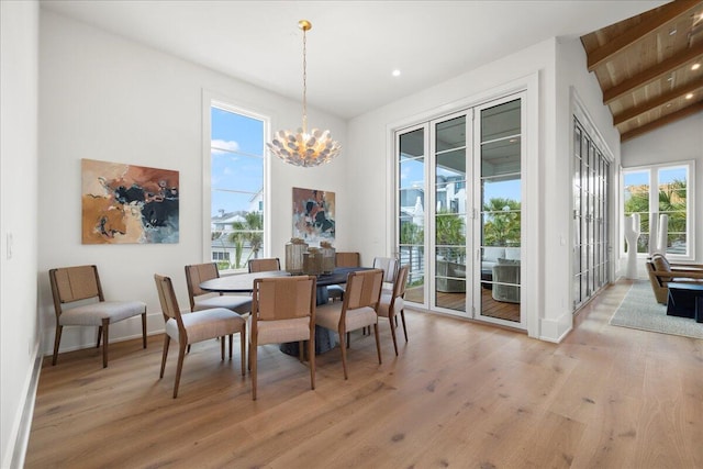 160 Heritage Dunes Ln S, Santa Rosa Beach, FL 32459 - dining space featuring baseboards, light wood-style floors, an inviting chandelier, and vaulted ceiling with beams
