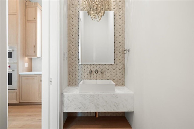 160 Heritage Dunes Ln S, Santa Rosa Beach, FL 32459 - bathroom with a sink, a chandelier, and wood finished floors