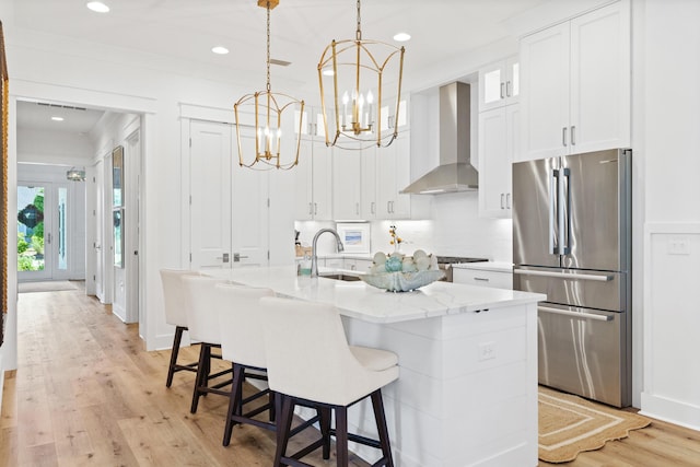 90 Basal St, Inlet Beach, FL 32461 - kitchen featuring freestanding refrigerator, wall chimney range hood, a sink, white cabinetry, and recessed lighting