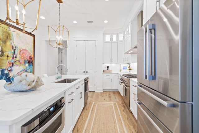 90 Basal St, Inlet Beach, FL 32461 - kitchen featuring appliances with stainless steel finishes, a sink, a chandelier, white cabinets, and light wood finished floors