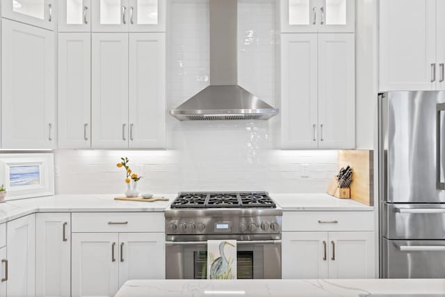 90 Basal St, Inlet Beach, FL 32461 - kitchen featuring appliances with stainless steel finishes, wall chimney range hood, decorative backsplash, white cabinetry, and glass insert cabinets