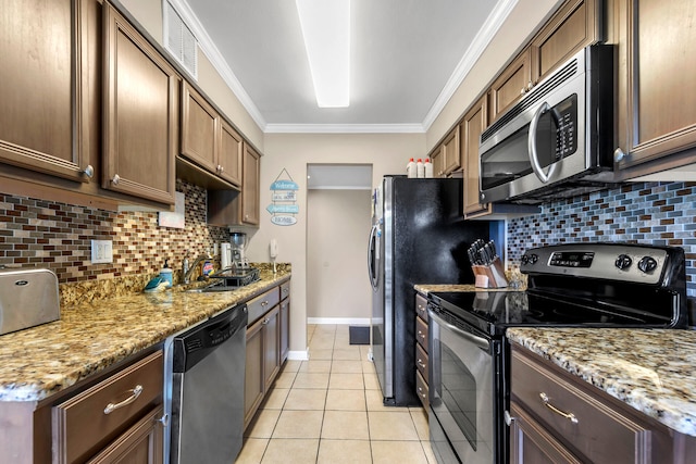 220 N Driftwood Bay Dr Unit 40A, Miramar Beach, FL 32550 - kitchen featuring backsplash, appliances with stainless steel finishes, light tile patterned floors, baseboards, and ornamental molding