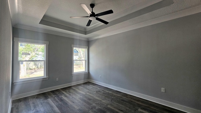 4200 Ida Coon Cir, Niceville, FL 32578 - empty room with a tray ceiling, a textured ceiling, ornamental molding, dark wood-type flooring, and baseboards