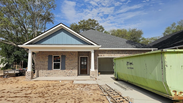 4200 Ida Coon Cir, Niceville, FL 32578 - view of front of property featuring brick siding, a porch, board and batten siding, and roof with shingles