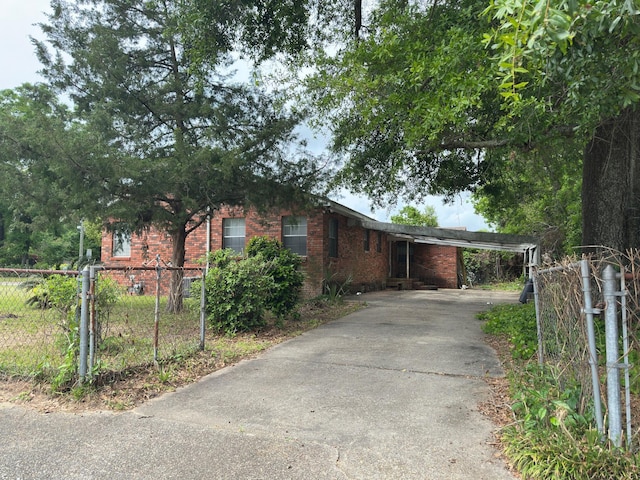 510 E Fisher St, Pensacola, FL 32503 - view of front of property featuring driveway, a carport, brick siding, and fence private yard