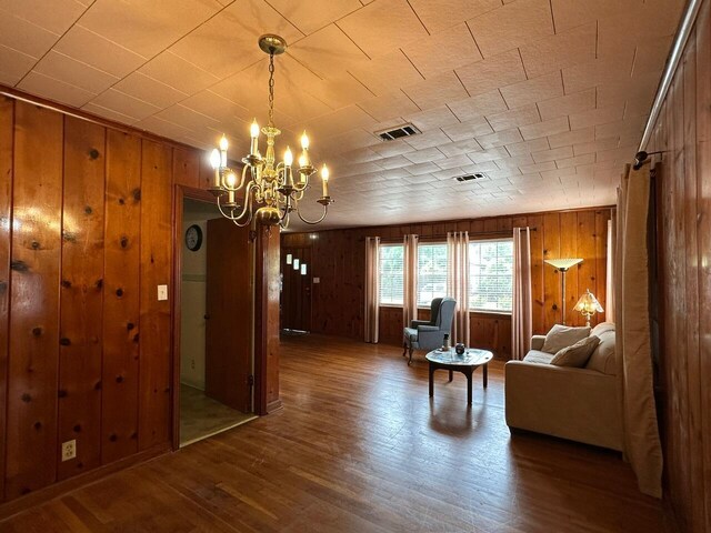 510 E Fisher St, Pensacola, FL 32503 - living area with visible vents, a notable chandelier, and wooden walls