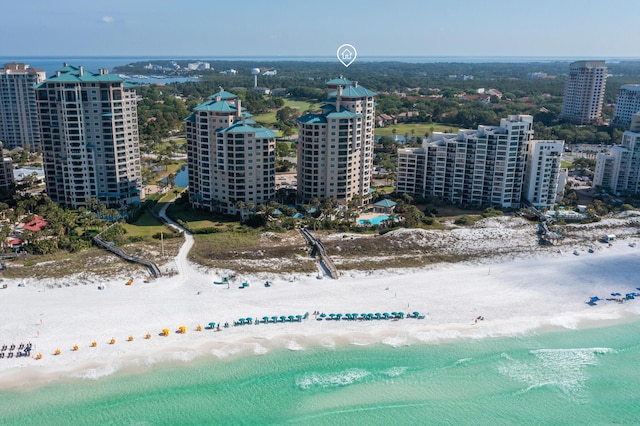 drone / aerial view with a beach view and a water view