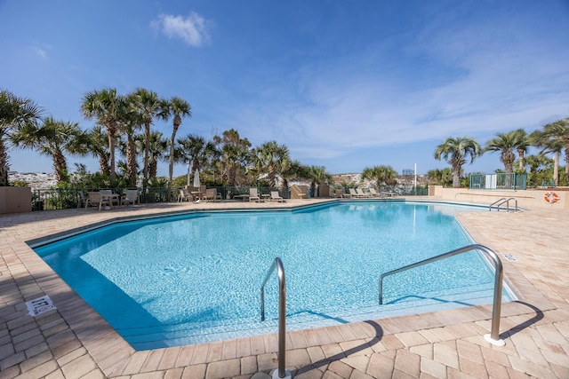 pool featuring a patio and fence
