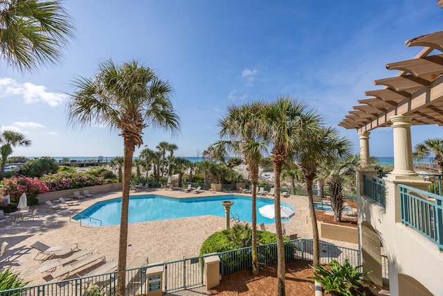 community pool with fence, a patio, and a pergola