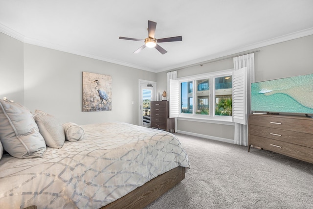 carpeted bedroom with baseboards, ornamental molding, and a ceiling fan