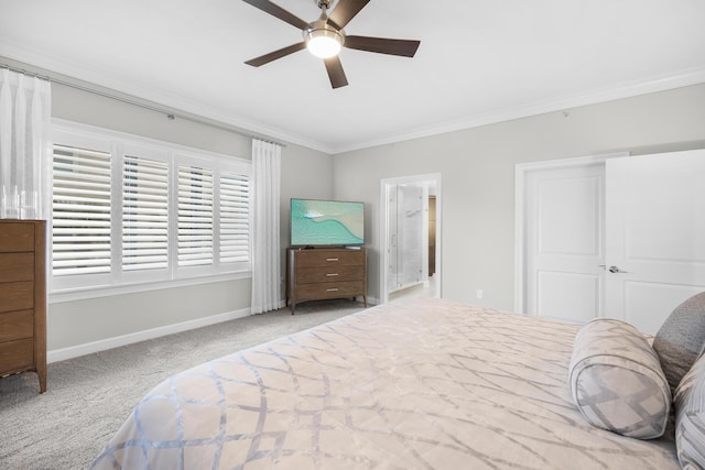 carpeted bedroom with baseboards, ornamental molding, and a ceiling fan