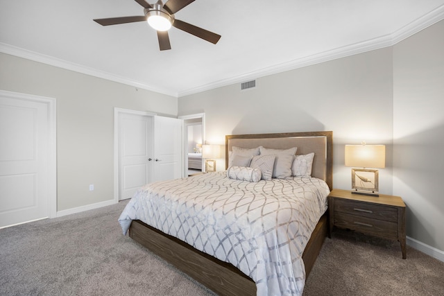 carpeted bedroom with baseboards, ornamental molding, ceiling fan, and visible vents