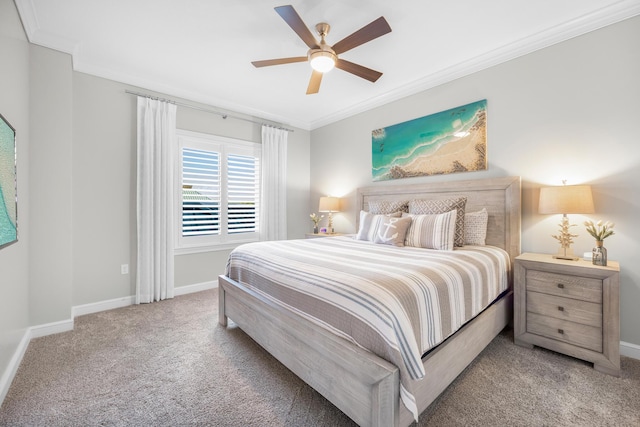 carpeted bedroom with baseboards, ornamental molding, and a ceiling fan